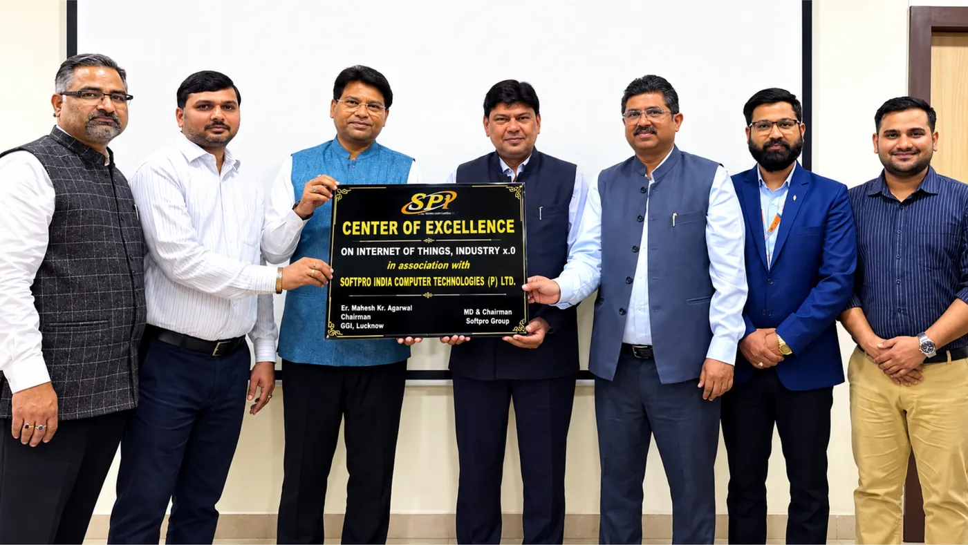 Seven people holding the Center of Excellence name plate between them