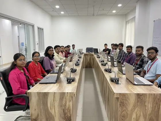 Wide view of the training room, every place at the bench taken and a laptop at each one
