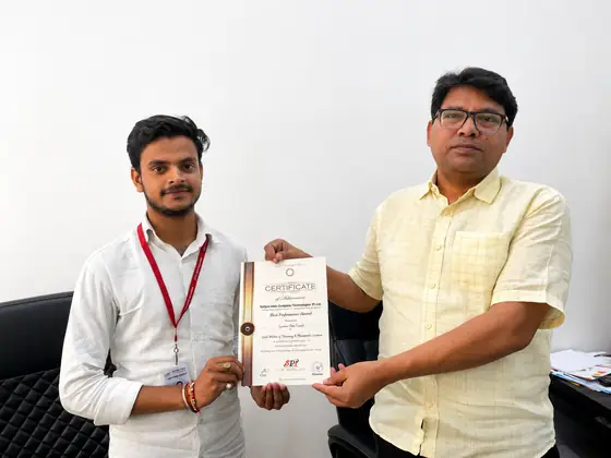 Two men holding a Softpro certificate of achievement between them for the camera