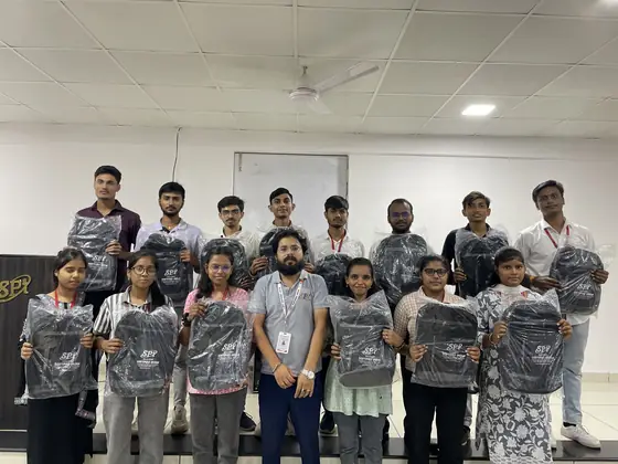 A batch standing on stage with their Softpro training kit bags
