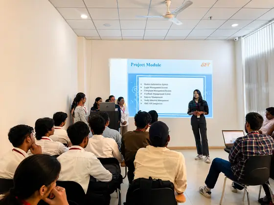 A student presenting a project module breakdown to a seated classroom