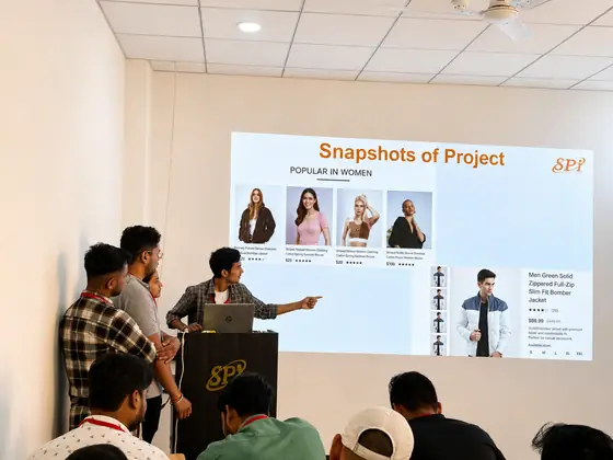 A team presenting screenshots of an e-commerce build to the room