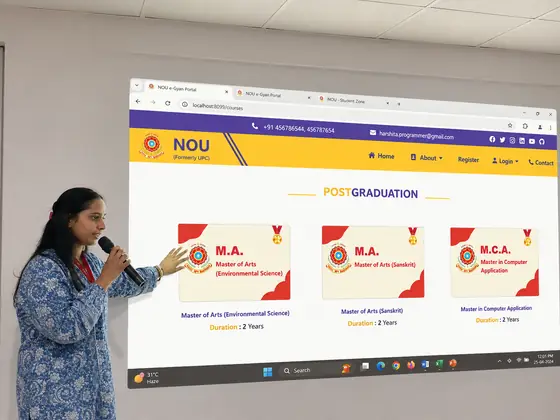 A student demonstrating a university admissions portal on the projector, pointing at the programme cards