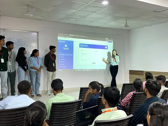 A team of five presenting the profile screen of a web portal they built