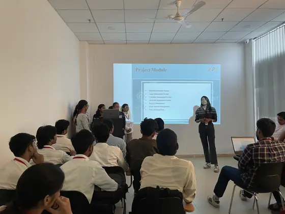 A student presenting a project module list to a classroom of seated students