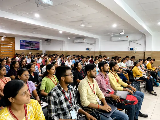 Students watching the screen intently during a technical session