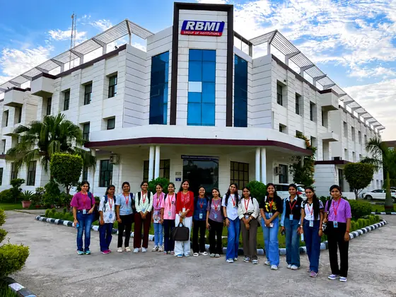 A group of students standing outside a college building before a workshop