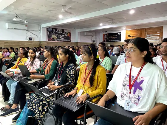Students seated with laptops through a hands-on session